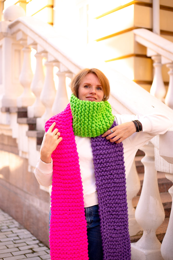 Woman wearing a colorful scarf in bright pink, green and purple