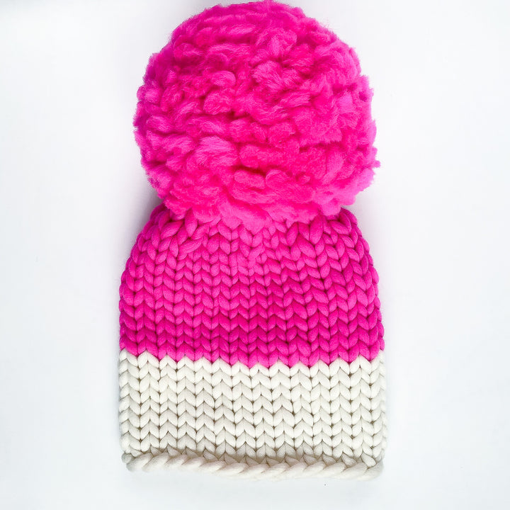 bright neon pink beanie with large pom pom