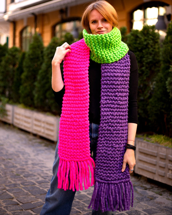 Colorful scarf with fringes showcasing vibrant pink, green, and purple colors, perfect for winter wear.