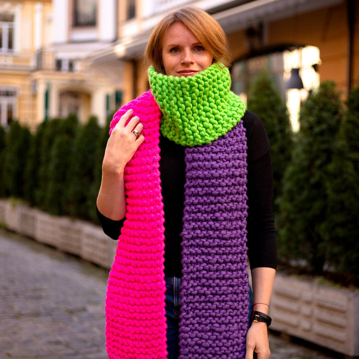 Woman wearing a pink purple green chunky knit scarf