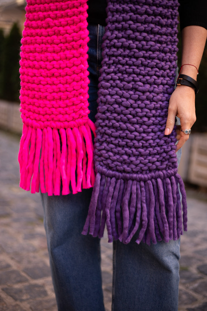 Colorful scarf featuring bright pink and purple fringes, hand knitted from soft merino wool, ideal for winter fashion.