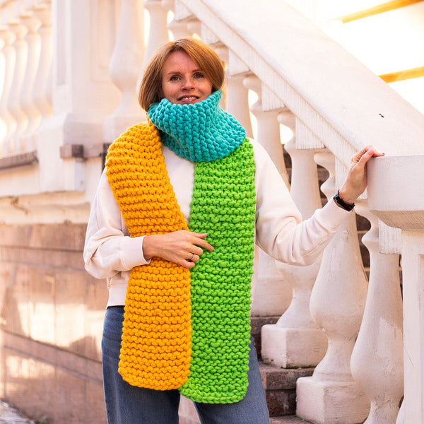 Woman wearing a colorful scarf on a white staircase