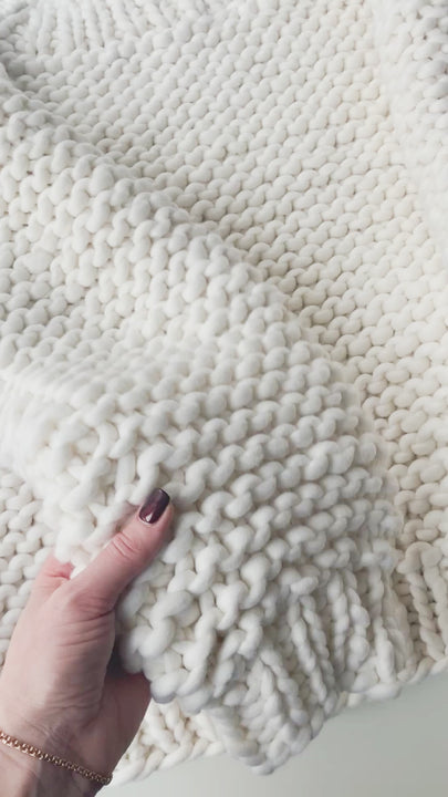 White chunky sweater sleeve texture close-up video