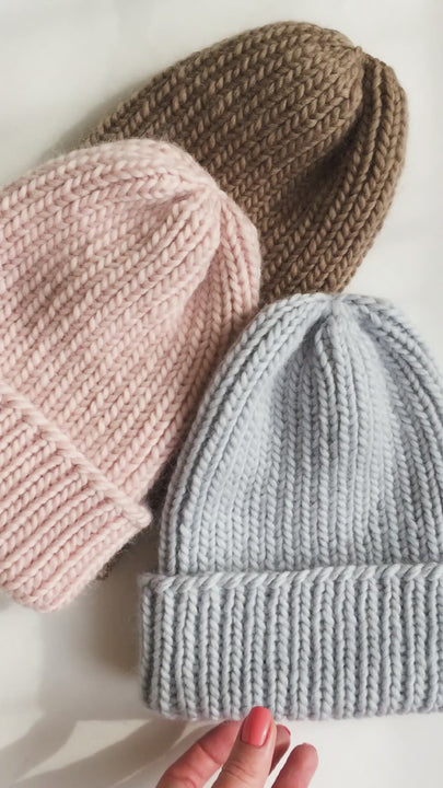 Three ribbed knitted beanies in light blue, powder pink and brown