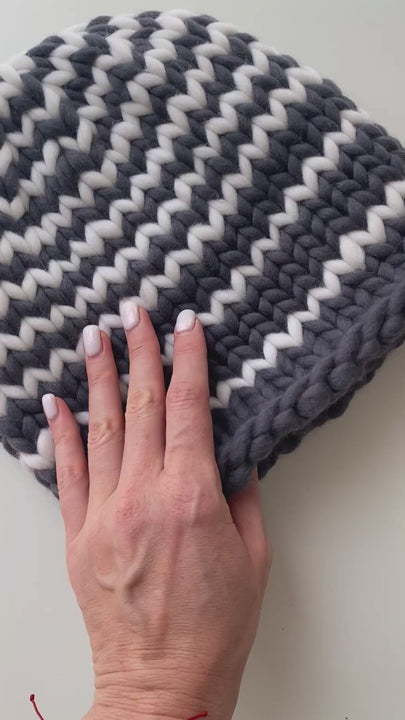 Flat lay video of striped knit beanie in grey and white merino wool