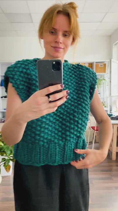 Chunky knit sweater vest in teal wool shown on model